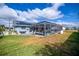 Expansive backyard with screened-in pool area, offering a private and relaxing outdoor space at 19983 Midway Blvd, Port Charlotte, FL 33948