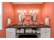 Bathroom featuring double sinks, vintage lighting, and coral walls at 19983 Midway Blvd, Port Charlotte, FL 33948