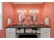 Modern bathroom with dual vessel sinks, dark wood countertop, and vibrant coral walls at 19983 Midway Blvd, Port Charlotte, FL 33948