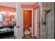 Stylish bathroom featuring double sinks, walk-in shower, and vibrant accent walls at 19983 Midway Blvd, Port Charlotte, FL 33948