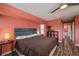 Spacious bedroom with a large bed, wood floors, a ceiling fan, and closet in the doorway at 19983 Midway Blvd, Port Charlotte, FL 33948