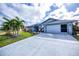 Single-story home with a large driveway and attached two-car garage at 19983 Midway Blvd, Port Charlotte, FL 33948