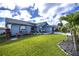 Charming single-story home with well-manicured lawn, attractive landscaping, and inviting curb appeal at 19983 Midway Blvd, Port Charlotte, FL 33948
