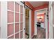 Hallway view featuring a barn door to the walk-in closet and doorway into the ensuite bathroom at 19983 Midway Blvd, Port Charlotte, FL 33948