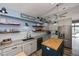 Modern kitchen featuring wood accents, stainless steel appliances, gray countertops and a blue wall at 19983 Midway Blvd, Port Charlotte, FL 33948