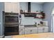 Modern kitchen featuring stainless steel appliances, a black vent hood, and open shelving at 19983 Midway Blvd, Port Charlotte, FL 33948