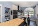 Modern kitchen featuring wood breakfast bar with stainless steel oven and large arched window at 19983 Midway Blvd, Port Charlotte, FL 33948