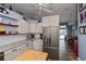 Kitchen featuring wood accents, gray countertops, stainless steel appliances, breakfast bar, and open access to other rooms at 19983 Midway Blvd, Port Charlotte, FL 33948