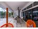 Comfortable covered lanai with a dining table, fan, and seamless access from the home through sliding glass doors at 19983 Midway Blvd, Port Charlotte, FL 33948