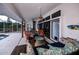 Relaxing covered lanai with stylish seating, chandelier, and sliding glass doors for seamless indoor-outdoor living at 19983 Midway Blvd, Port Charlotte, FL 33948