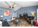 Comfortable living room featuring a vaulted ceiling, ceiling fan, and stylish furnishings at 19983 Midway Blvd, Port Charlotte, FL 33948