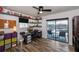 Office with a desk setup, backyard pool access, a ceiling fan, and hardwood floors at 19983 Midway Blvd, Port Charlotte, FL 33948