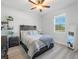 Cozy bedroom featuring a rustic wood bed frame and built-in shelving at 23071 Mineral Ave, Port Charlotte, FL 33954