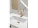 Modern bathroom sink with gold faucet and white countertop at 2516 Crittendon St, North Port, FL 34286