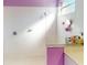 Bright bathroom featuring a tiled shower with glass enclosure and a charming lavender accent wall at 3097 Royal Palm Dr, North Port, FL 34288