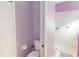 Bathroom with lavender accents featuring a toilet and a shower with a glass enclosure at 3097 Royal Palm Dr, North Port, FL 34288