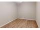 Minimalist bedroom with light hardwood flooring and neutral paint, awaiting personal touches at 3097 Royal Palm Dr, North Port, FL 34288