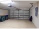 Spacious garage with paneled door, overhead storage and access to the house at 3097 Royal Palm Dr, North Port, FL 34288