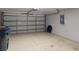 Spacious two-car garage with overhead door, a storage bin, and concrete flooring at 3097 Royal Palm Dr, North Port, FL 34288