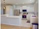 Spacious kitchen featuring white cabinets, stainless steel appliances, and a breakfast bar at 3097 Royal Palm Dr, North Port, FL 34288