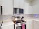 Modern kitchen featuring stainless steel appliances and white cabinetry at 3097 Royal Palm Dr, North Port, FL 34288