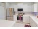Modern kitchen with stainless steel appliances, granite countertops, white cabinetry, and a stylish backsplash at 3097 Royal Palm Dr, North Port, FL 34288