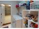 Laundry area with washer, dryer, storage shelves, and access to the garage at 3097 Royal Palm Dr, North Port, FL 34288