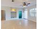 Bright living room with tile flooring, a ceiling fan, and a built-in alcove for entertainment at 3097 Royal Palm Dr, North Port, FL 34288