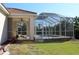 View of pool and patio area from the backyard with lawn at 3097 Royal Palm Dr, North Port, FL 34288
