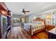 Large main bedroom with wood floors, ceiling fan, and sliding doors to the pool area at 3225 Antigua Dr, Punta Gorda, FL 33950