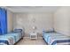 Bedroom with twin beds, nightstand and blue curtains at 3310 Middletown St, Port Charlotte, FL 33952