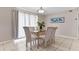 Bright dining room with glass-top table and six chairs, near kitchen at 3310 Middletown St, Port Charlotte, FL 33952