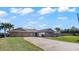 Attractive home with stone facade and a large driveway, offering curb appeal at 3310 Middletown St, Port Charlotte, FL 33952