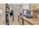 Modern kitchen with stainless steel appliances and tile countertops at 3310 Middletown St, Port Charlotte, FL 33952