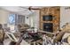 Comfortable living room with a stone fireplace and plenty of natural light at 3310 Middletown St, Port Charlotte, FL 33952