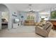 Bright living room featuring tan leather furniture and access to a bedroom at 3619 Coquina Ave, North Port, FL 34286