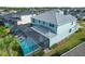 Aerial view showcasing the home's exterior, pool, and landscaping at 43660 Tree Top Trl, Punta Gorda, FL 33982