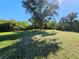Large backyard with lush green grass and mature trees at 6222 Berkeley St, Englewood, FL 34224