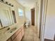 Clean bathroom with shower, toilet, vanity sink and linen closet at 6222 Berkeley St, Englewood, FL 34224