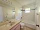 Clean bathroom with a bathtub, toilet and sink at 6222 Berkeley St, Englewood, FL 34224