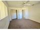 Bedroom with ceiling fan, carpet flooring, and spacious closet at 6222 Berkeley St, Englewood, FL 34224