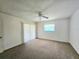 Spacious bedroom with carpet flooring, ceiling fan, and sliding glass door access at 6222 Berkeley St, Englewood, FL 34224