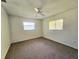 Bedroom with ceiling fan, carpet flooring, and ample closet space at 6222 Berkeley St, Englewood, FL 34224