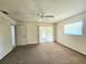 Bright bedroom featuring carpet, ceiling fan, and access to patio at 6222 Berkeley St, Englewood, FL 34224