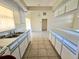 White kitchen with island and tile floor at 6222 Berkeley St, Englewood, FL 34224