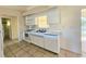 White kitchen with appliances and tile floor at 6222 Berkeley St, Englewood, FL 34224