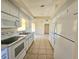 Efficient kitchen with white cabinets and tile floor at 6222 Berkeley St, Englewood, FL 34224