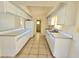 Efficient kitchen with white cabinets and tiled floors at 6222 Berkeley St, Englewood, FL 34224