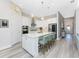 Modern white kitchen with center island and stainless steel appliances at 6259 Crested Eagle Ln, Nokomis, FL 34275