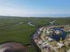 Aerial view showcasing the waterfront property's location with bay views and lush green surroundings at 649 Maltese Dr, Punta Gorda, FL 33950